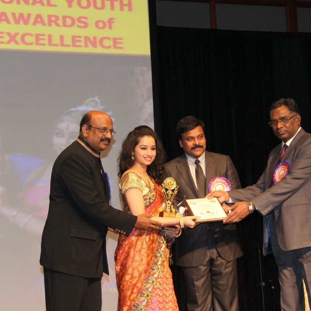 Pranamya Suri receiving award on stage